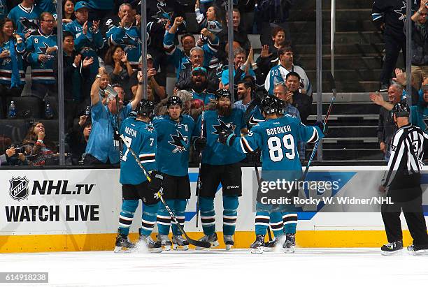 Brent Burns of the San Jose Sharks celebrates with teammates after scoring a goal against the Los Angeles Kings at SAP Center on October 12, 2016 in...