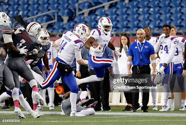 Louisiana Tech Bulldogs wide receiver Carlos Henderson hurdles a Minuteman for extra yardage. The Louisiana Tech Bulldogs defeated the UMass...