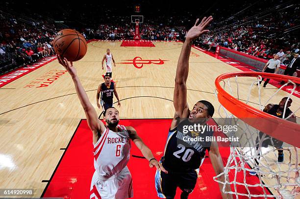 Tyler Ennis of the Houston Rockets goes up for a shot against D.J. Stephens of the Memphis Grizzlies during a preseason game on October 15, 2016 at...