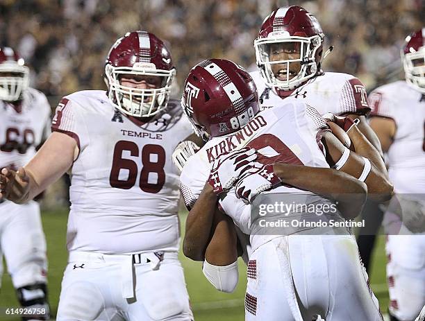 Temple players celebrate with wide receiver Keith Kirkwood after he pulled down a game-winning touchdown catch against UCF at Bright House Networks...