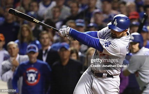 Adrian Gonzalez of the Los Angeles Dodgers hits a two-run RBI single in the eighth inning against the Chicago Cubs during game one of the National...