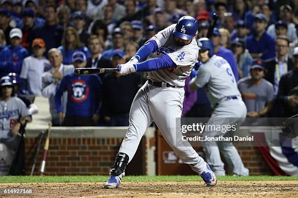 Adrian Gonzalez of the Los Angeles Dodgers hits a two-run RBI single in the eighth inning against the Chicago Cubs during game one of the National...