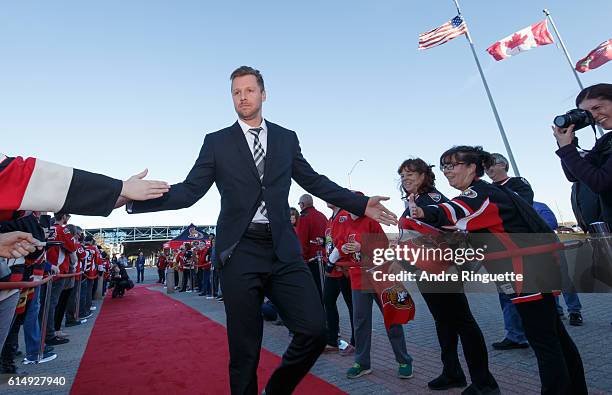 Marc Methot of the Ottawa Senators walks down the red carpet prior to a game against the Toronto Maple Leafs at Canadian Tire Centre during the...