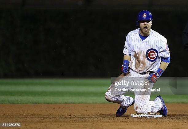 Ben Zobrist of the Chicago Cubs reacts after hitting a double in the eighth inning against the Los Angeles Dodgers during game one of the National...