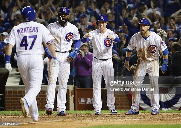 Miguel Montero of the Chicago Cubs celebrates with Jason Heyward, Chris Coghlan and Ben Zobrist after hitting a grand slam home run in the eighth...