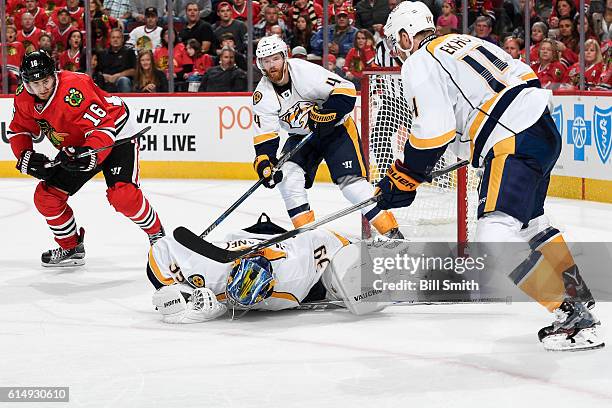 Goalie Marek Mazanec of the Nashville Predators covers the puck in front of Marcus Kruger of the Chicago Blackhawks and Ryan Ellis in the third...