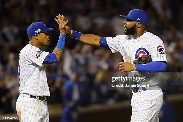 Addison Russell celebrates with Jason Heyward of the Chicago Cubs after defeating the Los Angeles Dodgers 8-4 in game one of the National League...
