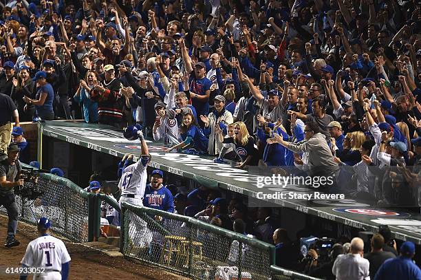 Miguel Montero of the Chicago Cubs celebrates at the dugout after hitting a grand slam home run in the eighth inning against the Los Angeles Dodgers...