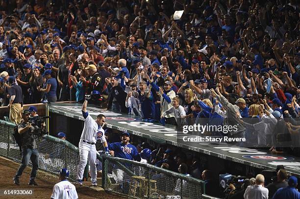 Miguel Montero of the Chicago Cubs celebrates at the dugout after hitting a grand slam home run in the eighth inning against the Los Angeles Dodgers...