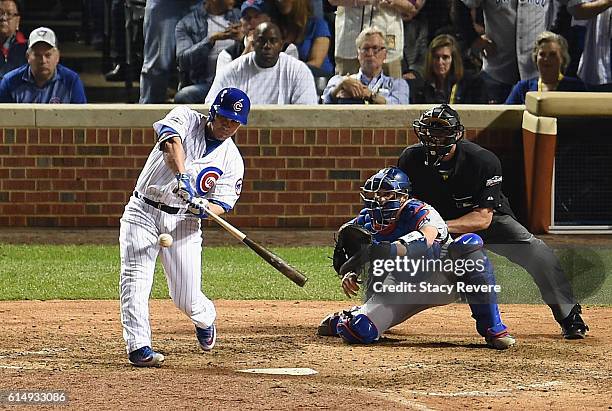 Miguel Montero of the Chicago Cubs hits a grand slam home run in the eighth inning against the Los Angeles Dodgers during game one of the National...