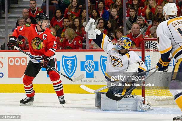 Nashville Predators Goalie Marek Mazanec reaches for a puck next to Chicago Blackhawks Center Jonathan Toews in the 3rd period during a game between...