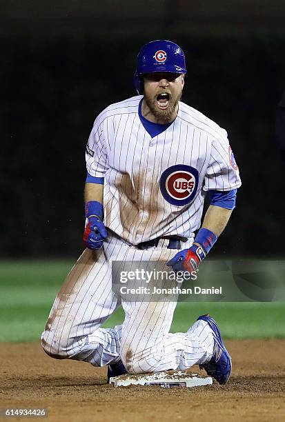 Ben Zobrist of the Chicago Cubs reacts after hitting a double in the eighth inning against the Los Angeles Dodgers during game one of the National...