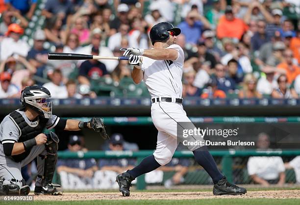 Tyler Collins of the Detroit Tigers watches his game-winning sacrifice fly ball while catcher Alex Avila of the Chicago White Sox looks on at...