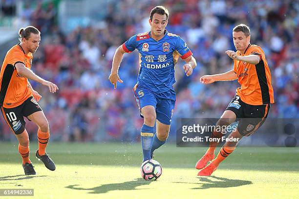 Benjamin Kantarovski of the Jets controls the ball from Brett Holman and Thomas Kristensen of the Roar during the round two A-League match between...