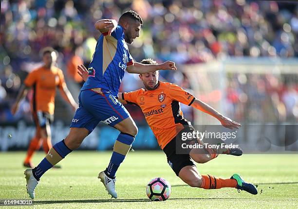 Andrew Nabbout of the Jets contests the ball with Thomas Oar of the Roar during the round two A-League match between the Newcastle Jets and the...