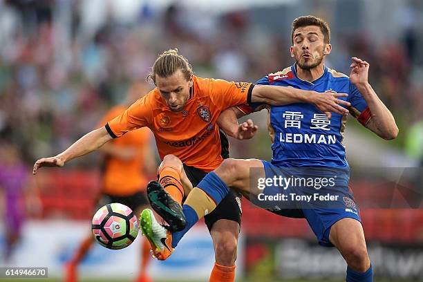Mateo Poljak of the Jets and Brett Holman of the Roar contest the ball during the round two A-League match between the Newcastle Jets and the...