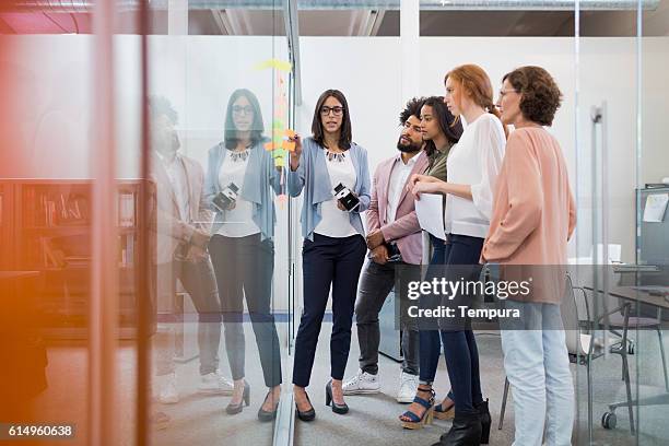 business people brainstorming in conference room. - casual female business leader stock pictures, royalty-free photos & images