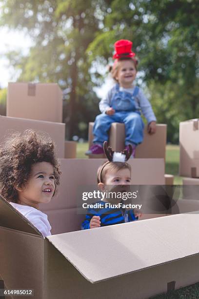 three multi ethnic babies playing outside - xmas eps stockfoto's en -beelden