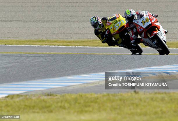 Honda Team Asia's Thai rider Ratthapark Wilairot leads Paginas Amarillas HP 40's Spanish rider Edgar Pons during the Moto2 race at the Japanese Grand...