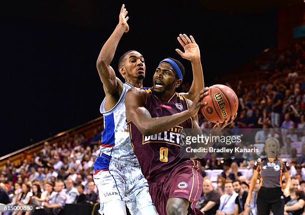 Jermaine Beal of the Bullets takes on the defence of Terrance Ferguson of Adelaide during the round two NBL match between the Brisbane Bullets and...