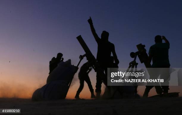 Fighters from the Free Syrian Army cheer and react as they fight against the Islamic State group jihadists on the outskirts of the northern Syrian...