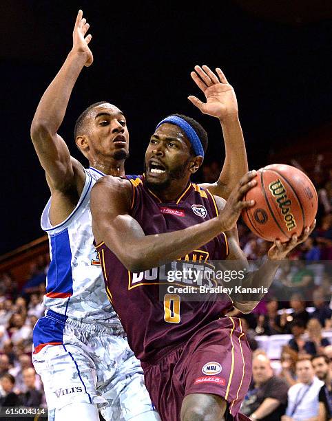 Jermaine Beal of the Bullets takes on the defence of Terrance Ferguson of Adelaide during the round two NBL match between the Brisbane Bullets and...