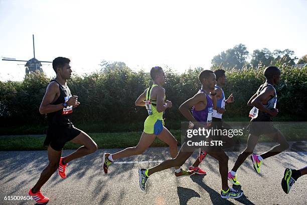 Men compete in the Amsterdam Marathon in Amsterdam, on October 16, 2016. / AFP / ANP / STR / Netherlands OUT