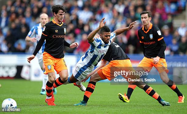 Elias Kachunga of Huddersfield Town trips after a collision with Daniel Pudil of Sheffield Wednesday during the Sky Bet Championship match between...