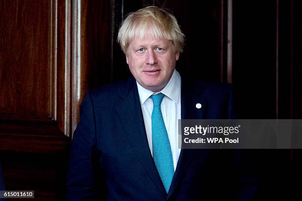 British Foreign Secretary Boris Johnson waits for the arrival of US Secretary of State John Kerry for a meeting on the situation in Syria at...