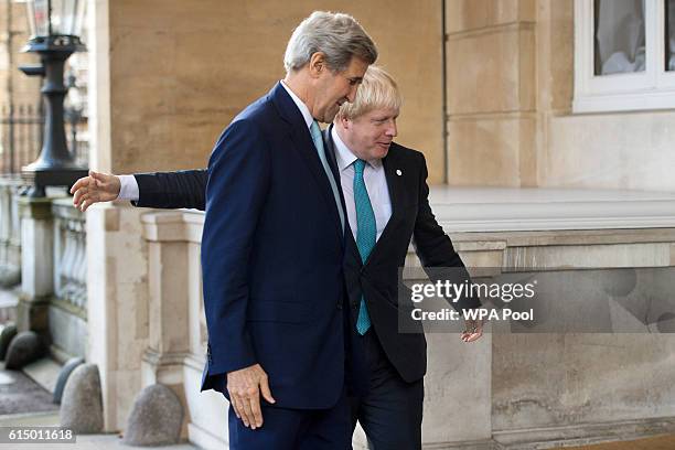 Secretary of State John Kerry is greeted by British Foreign Secretary Boris Johnson ahead of a meeting on the situation in Syria at Lancaster House...