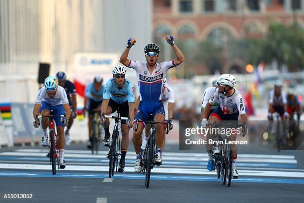 Peter Sagan of Slovakia celebrates victory as he crosses the finish line next to Mark Cavendish of Great Britain during the Elite Men's Road Race on...