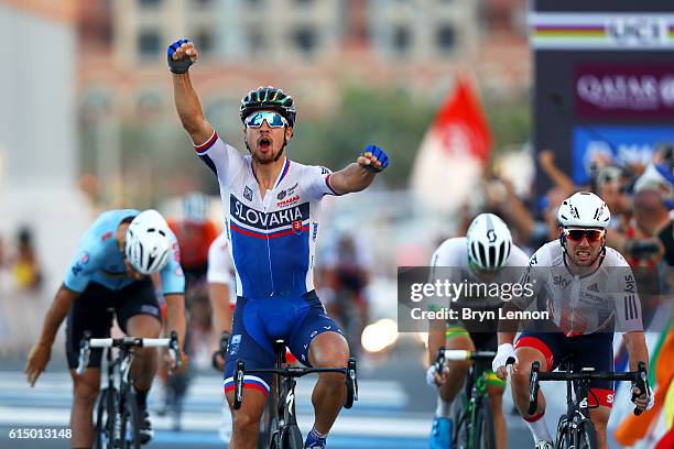 Peter Sagan of Slovakia celebrates victory as he crosses the finish line ahead of Mark Cavendish of Great Britain and Tom Boonen of Belgium in the...