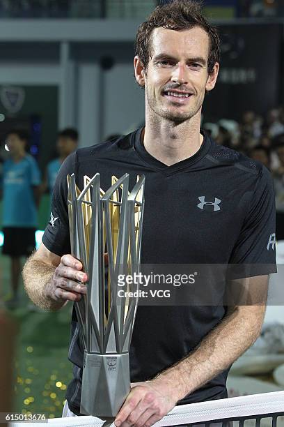 Andy Murray of Great Britain celebrates with the trophy after winning the Men's singles final match against Roberto Bautista Agut of Spain on day 8...