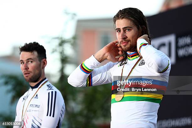 Peter Sagan of Slovakia celebrates victory on the podium next to Mark Cavendish of Great Britain after the Elite Men's Road Race on day eight of the...