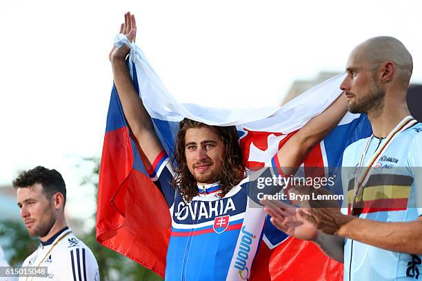 Peter Sagan of Slovakia celebrates victory on the podium next to second-placed Mark Cavendish of Great Britain and third-placed Tom Boonen of Belgium...