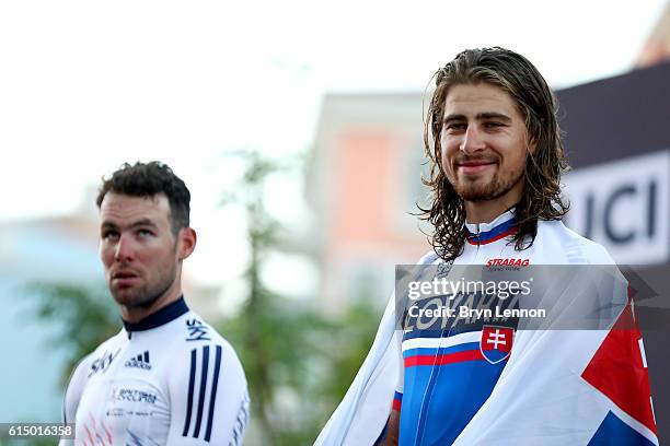 Peter Sagan of Slovakia celebrates victory on the podium next to Mark Cavendish of Great Britain after the Elite Men's Road Race on day eight of the...