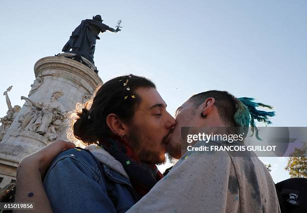 Men kiss one another during a "kiss-in" demonstration in defense of marriage equality, and against the Manif Pour Tous anti-same-sex marriage...