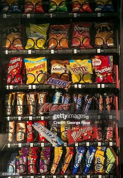 Vending machine packed with chocolate snacks and chips is viewed at London Heathrow International Airport's Terminal 2 on September 13 in London,...