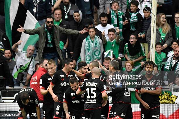 Dijon's French midfielder Pierre Lees-Melou is congratulated by teammates after scoring a goal during the French L1 football match AS Saint-Etienne...