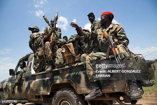 Soldiers of the Sudan People Liberation Army sit in a pick-up truck at the military base in Malakal, northern South Sudan, on October 16, 2016. Heavy...