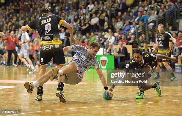 Benjamin Gille of Chambery Savoie HB, Kresimir Kozina of Fuechse Berlin and Melvyn Richardson of Chambery Savoie HB during the game between Fuechse...