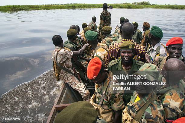 Soldiers of the Sudan People Liberation Army cross the Nile River in a boat in Malakal, northern South Sudan, on October 16, 2016. Heavy fighting...