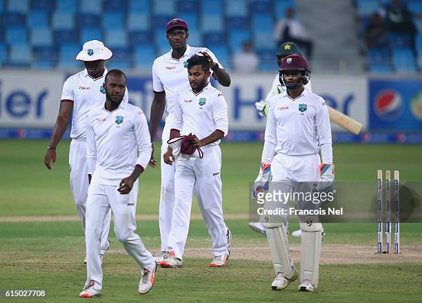 Devendra Bishoo of West Indies is congratulated by Jason Holder of West Indies after dismissing Mohammad Amir of Pakistan during Day Four of the...