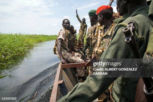 Soldiers of the Sudan People Liberation Army cross the Nile River in a boat near Malakal, northern South Sudan, on October 16, 2016. Heavy fighting...