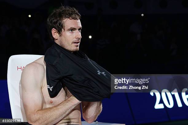 Andy Murray of Great Britain changes his shirt before the award ceremony after winning the Men's singles final match against Roberto Bautista Agut of...