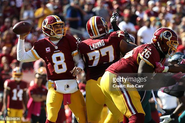 Quarterback Kirk Cousins of the Washington Redskins passes the ball while teammate guard Shawn Lauvao blocks against the Philadelphia Eagles in the...
