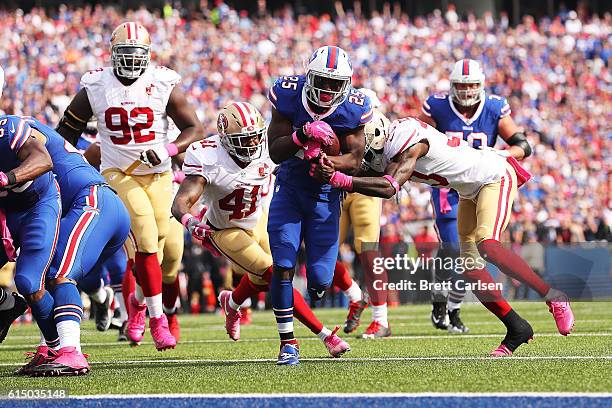 LeSean McCoy of the Buffalo Bills breaks a tackle by Rashard Robinson of the San Francisco 49ers for a touchdown during the first half at New Era...