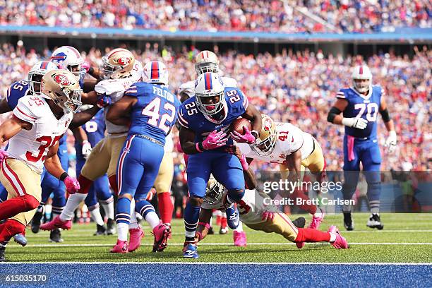 LeSean McCoy of the Buffalo Bills breaks a tackle by Rashard Robinson of the San Francisco 49ers for a touchdown during the first half at New Era...