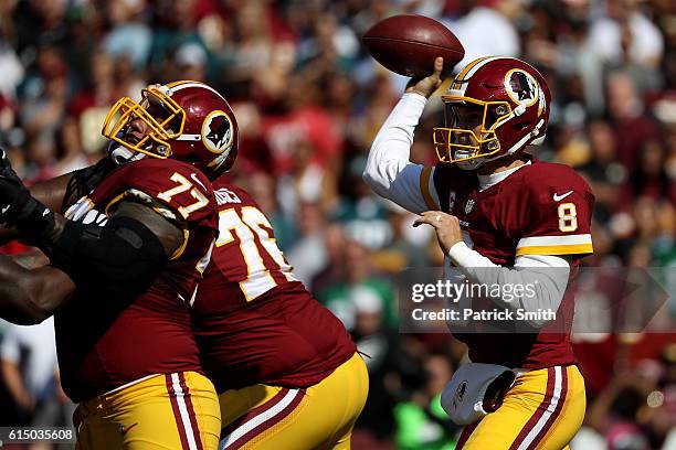 Quarterback Kirk Cousins of the Washington Redskins passes the ball while teammate guard Shawn Lauvao blocks against the Philadelphia Eagles in the...