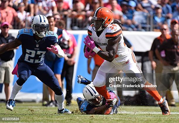 Isaiah Crowell of the Cleveland Browns rushes against Brice McCain of the Tennessee Titans during the first half at Nissan Stadium on October 16,...